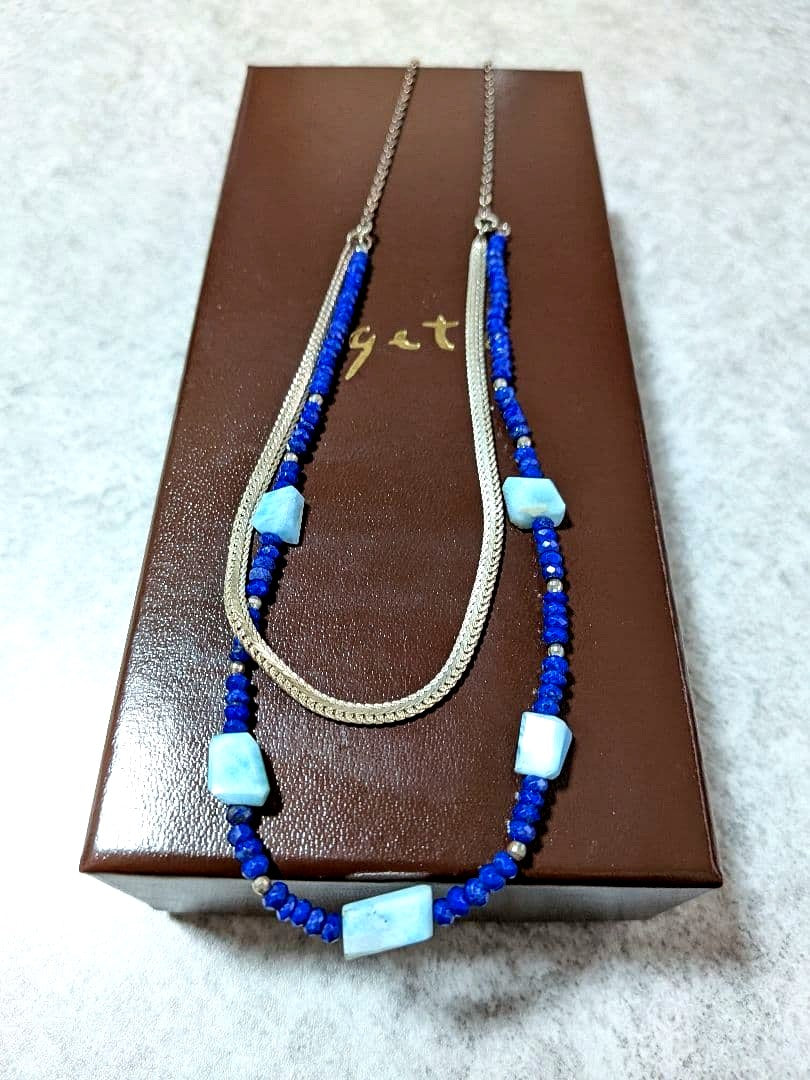 Agete silver double necklace with blue beads featuring a two-strand design, displayed on a white background