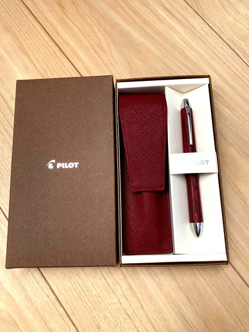 Pilot 3-color ballpoint pen showing red, blue, and black ink with included pen case