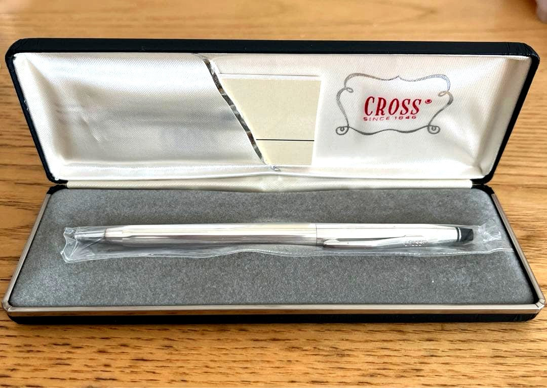 Unused Cross ballpoint pen in original packaging with slight discoloration and tarnish from long-term storage
