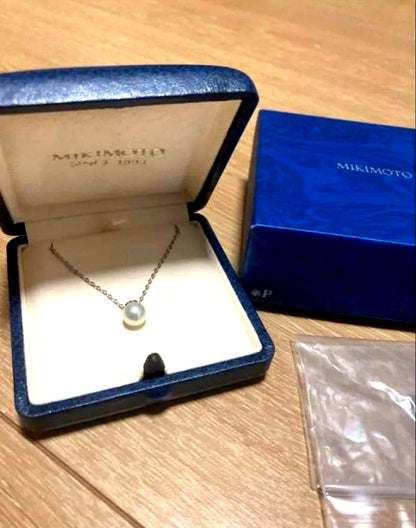 Close-up of Mikimoto elegant pearl necklace with 7-8mm white pearls strung on a delicate chain