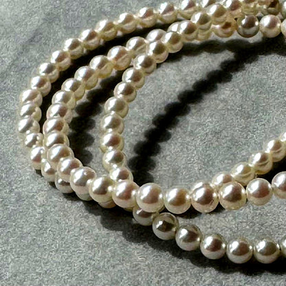 K18 Akoya baby pearl necklace with 3.0-3.5mm pearls and 42 cm length on white background