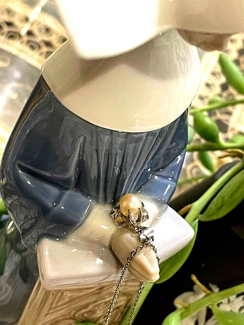 Mikimoto silver pearl necklace with flower motif and 41 cm chain on white background