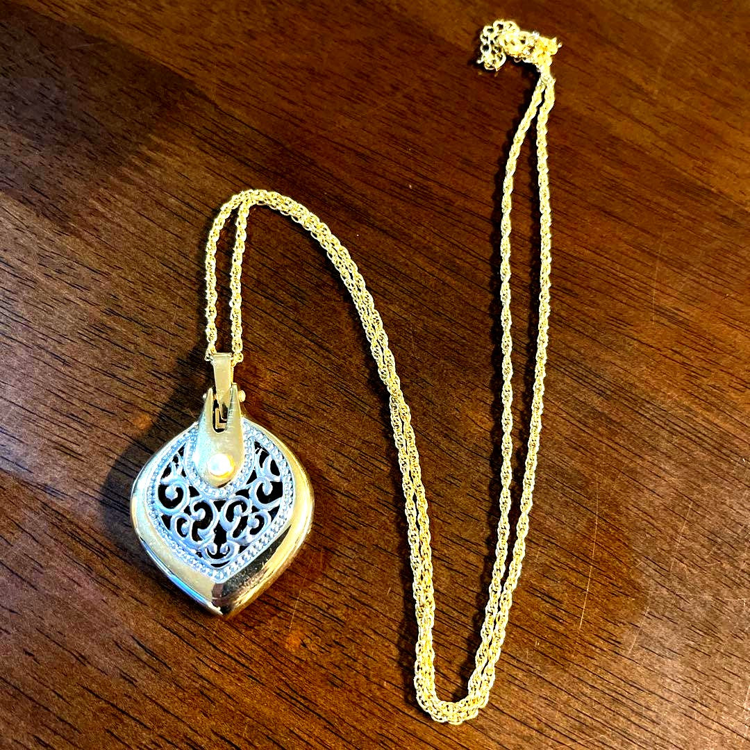 Mikimoto Loupe Pendant Pearl Necklace with a single white pearl and gold chain shown on a white background