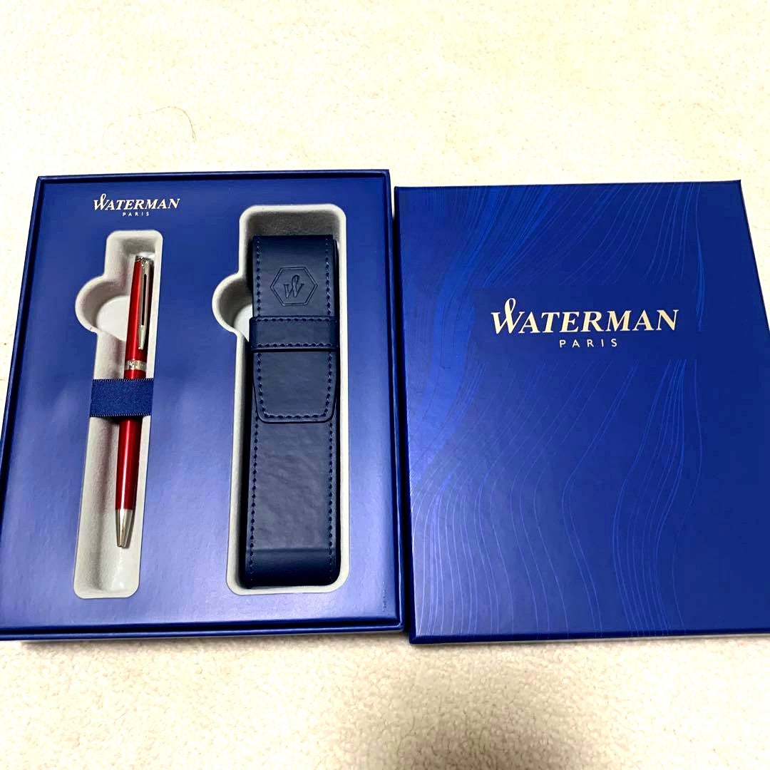 Unused Waterman red ballpoint pen paired with a blue pen case
