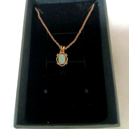 Ago oval-shaped opaque opal pendant gold necklace with pink, orange, and green colors on a rope chain