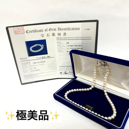 Akoya pearl necklace with 7mm pearls, silver clasp with inscription, displayed with certificate and case