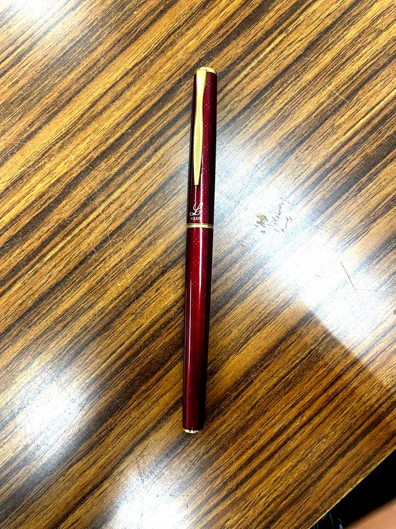 PILOT burgundy fountain pen with 14K gold fine nib displayed on white background