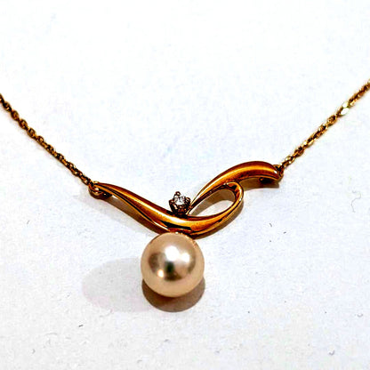 Mikimoto pearl necklace featuring a 7.3mm pearl and diamond set in 18K yellow gold with 42cm chain