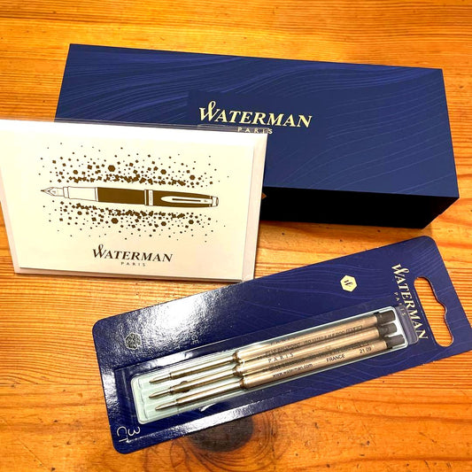 Waterman black metal ballpoint pen with replacement ink cartridges, approximately 14 cm long