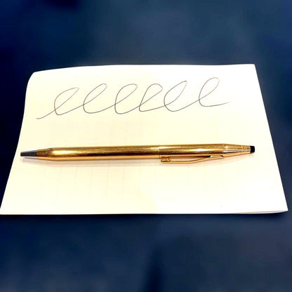 Kuro Cross Classic Century ballpoint pen with gold filled cap and barrel showing block letter logo
