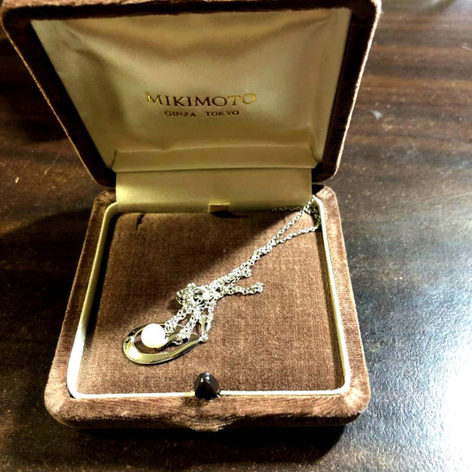 12330MIKIMOTO pearl necklace with 5.8mm pearls in silver displayed with dedicated case