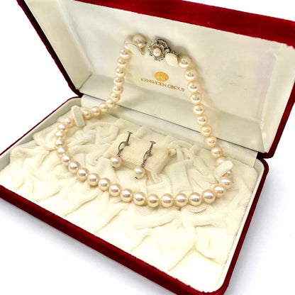 White Akoya pearl necklace and matching earrings with 8.5-9mm round pearls displayed on a white background