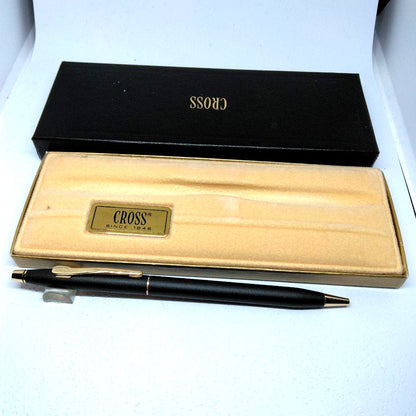 CROSS black ballpoint pen with gold accents displayed alongside its dedicated case