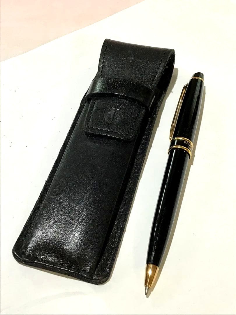 Waterman Paris black and gold ballpoint pen with leather case on white background