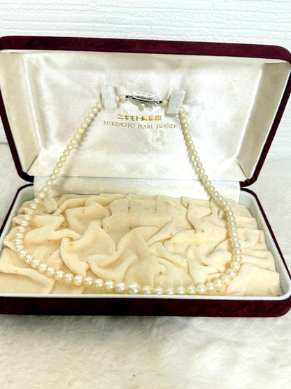 Mikimoto pearl necklace with white gold 14WG chain displayed alongside dedicated storage case