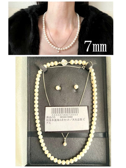 Akoya pearl necklace, earrings, and pendant set with white round pearls and silver chains on white background