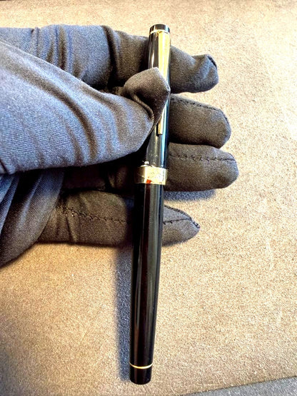 Elite black fountain pen with gold trim and gold finish clip made of metal, elegant design