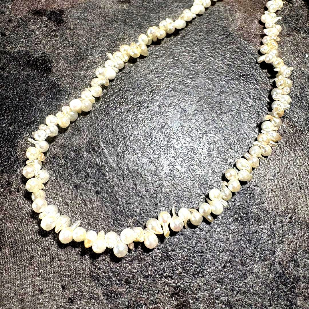 Akoya pearl necklace with silver clasp displayed on white background, 42 cm length