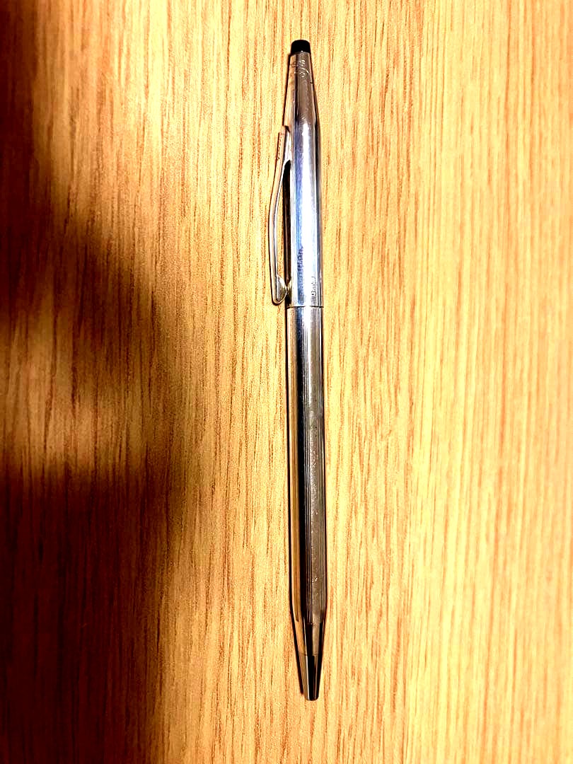 Kuro 925 silver ballpoint pen with slim body, black tip, and metal clip on a white background