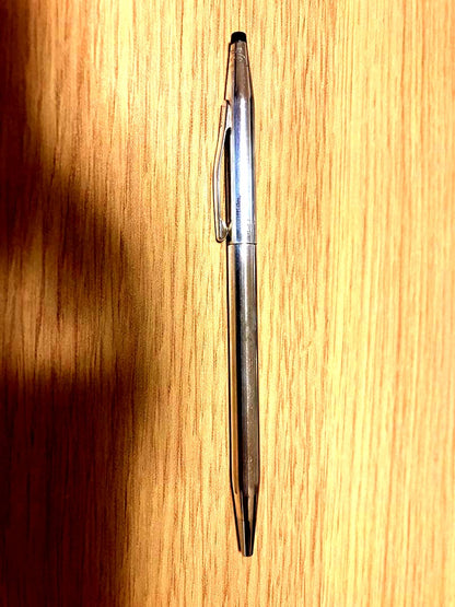 Kuro 925 silver ballpoint pen with slim body, black tip, and metal clip on a white background