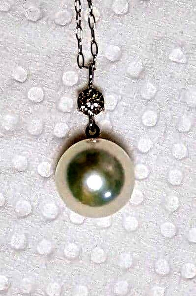 Akoya pearl and diamond pendant necklace featuring 8.3mm round white-green pearl with platinum chain