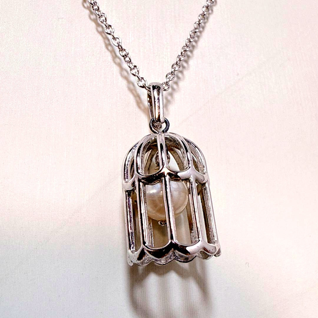 Tasaki Pearl Basket Necklace with bell sound made of 925 silver, shown on white background