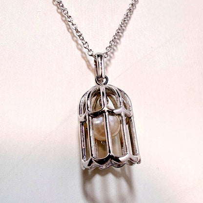 Tasaki Pearl Basket Necklace with bell sound made of 925 silver, shown on white background