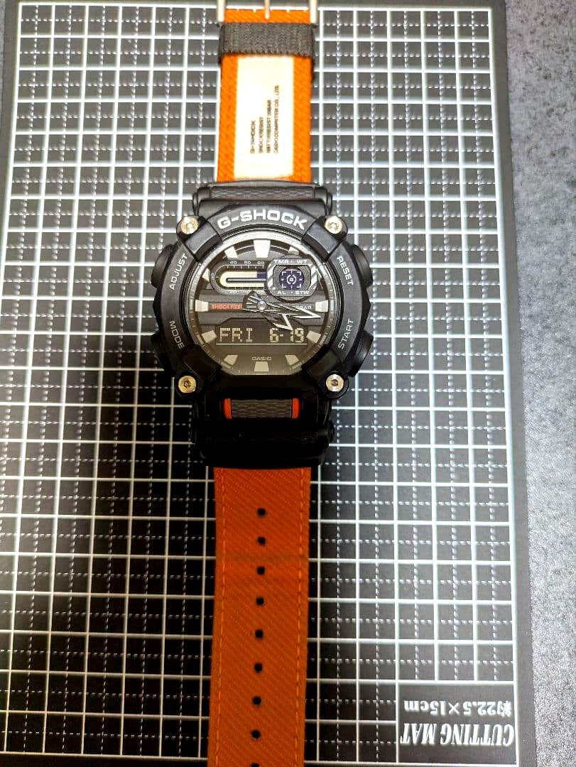 Casio G-Shock digital watch with orange body, shock-resistant and 20 ATM water resistance