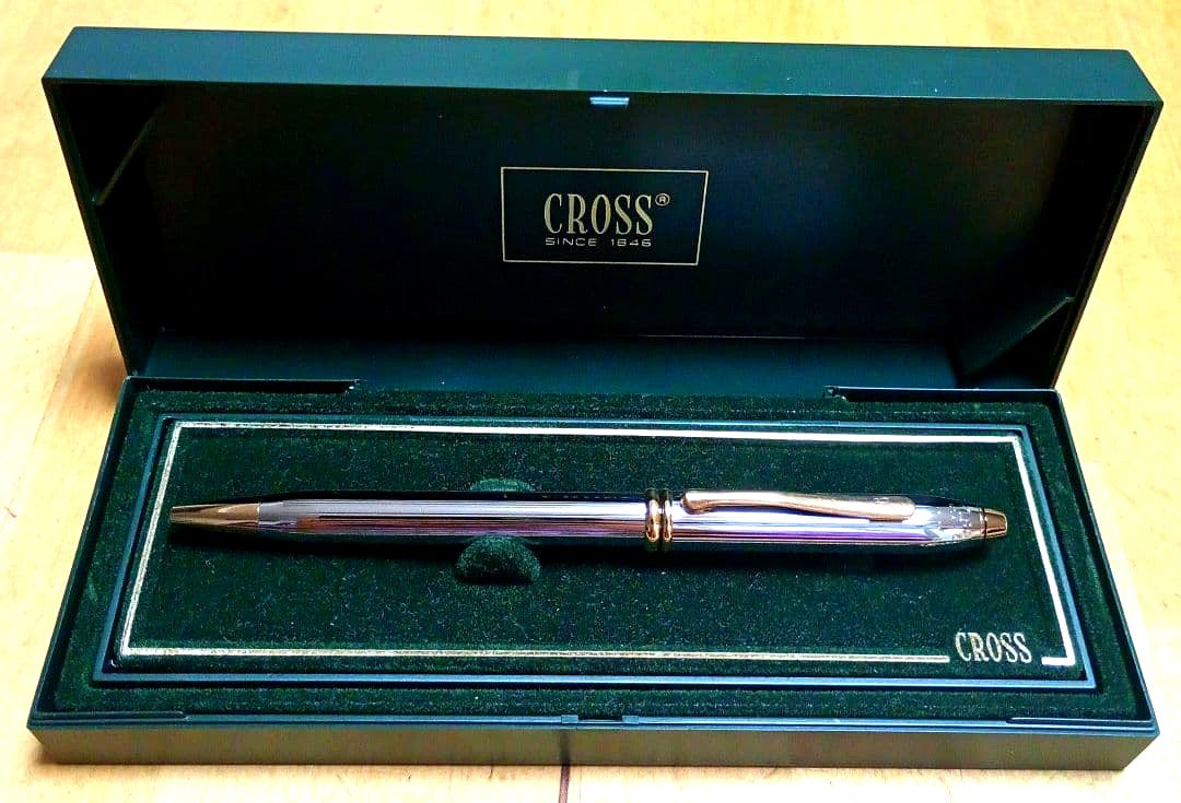 Cross ballpoint pen with metal body and blue ink displayed with its dedicated case and manual