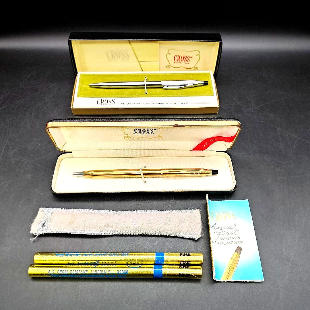 Two gold Cross ballpoint pens with case and two unused ink cartridges, each pen 5.5 inches long