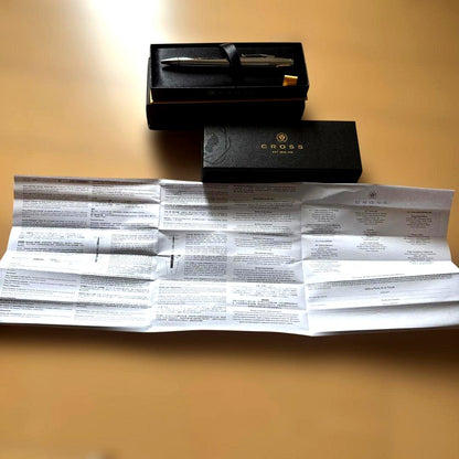 Cross Silver Ballpoint Pen with glossy finish alongside its dedicated case and instruction manual