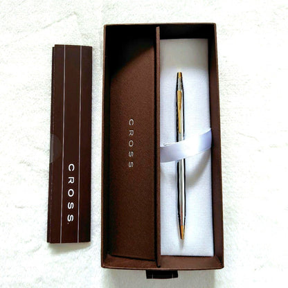 Cross brand silver and gold ballpoint pen with slim design, shown with box and instruction manual