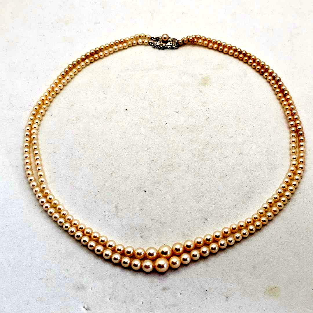Akoya pearl two-strand gradient necklace with silver clasp, 43cm length displayed on white background