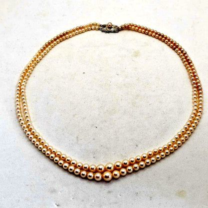 Akoya pearl two-strand gradient necklace with silver clasp, 43cm length displayed on white background