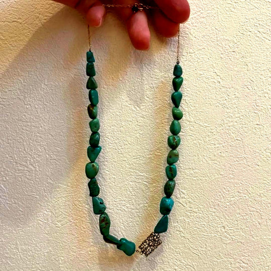 Agete necklace featuring 25 turquoise stones and 1 ruby stone with K10 gold-plated chain and openwork design