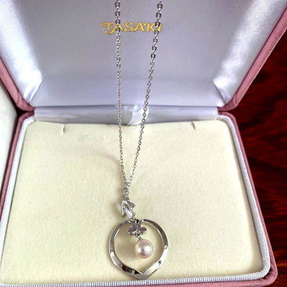 Silver TASAKI freshwater pearl pendant with certificate included on white background