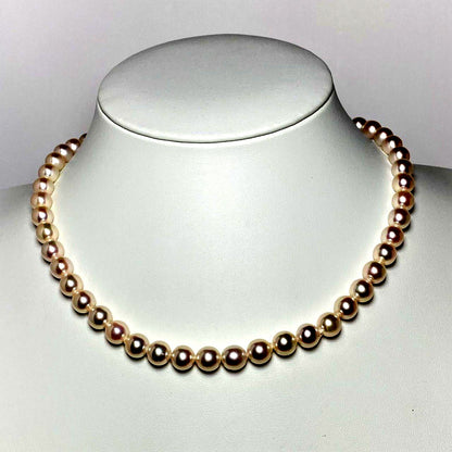 Akoya pearl necklace with 7.5-8.0mm white pearls, 42 cm length, displayed on a black velvet background
