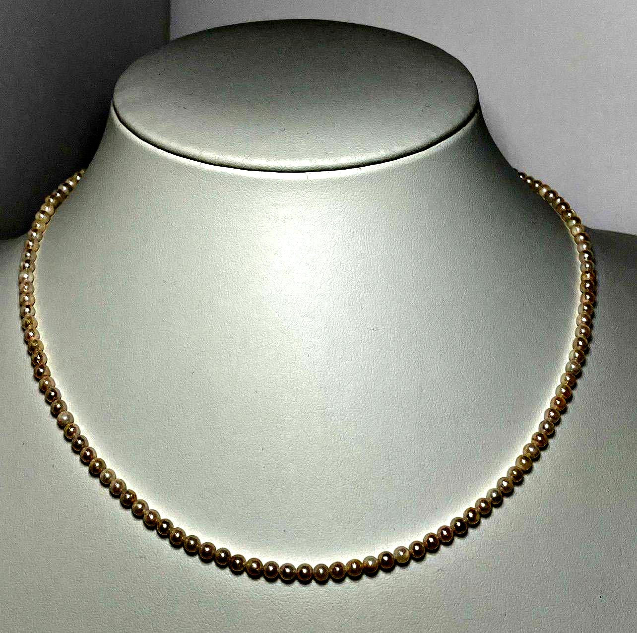 Akoya pearl baby pearl necklace with 3.0-3.5mm pearls and silver adjuster on white background