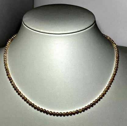 Akoya pearl baby pearl necklace with 3.0-3.5mm pearls and silver adjuster on white background