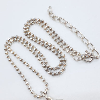 Agete heart-shaped silver necklace with heart rocket and clover charm on silver chain