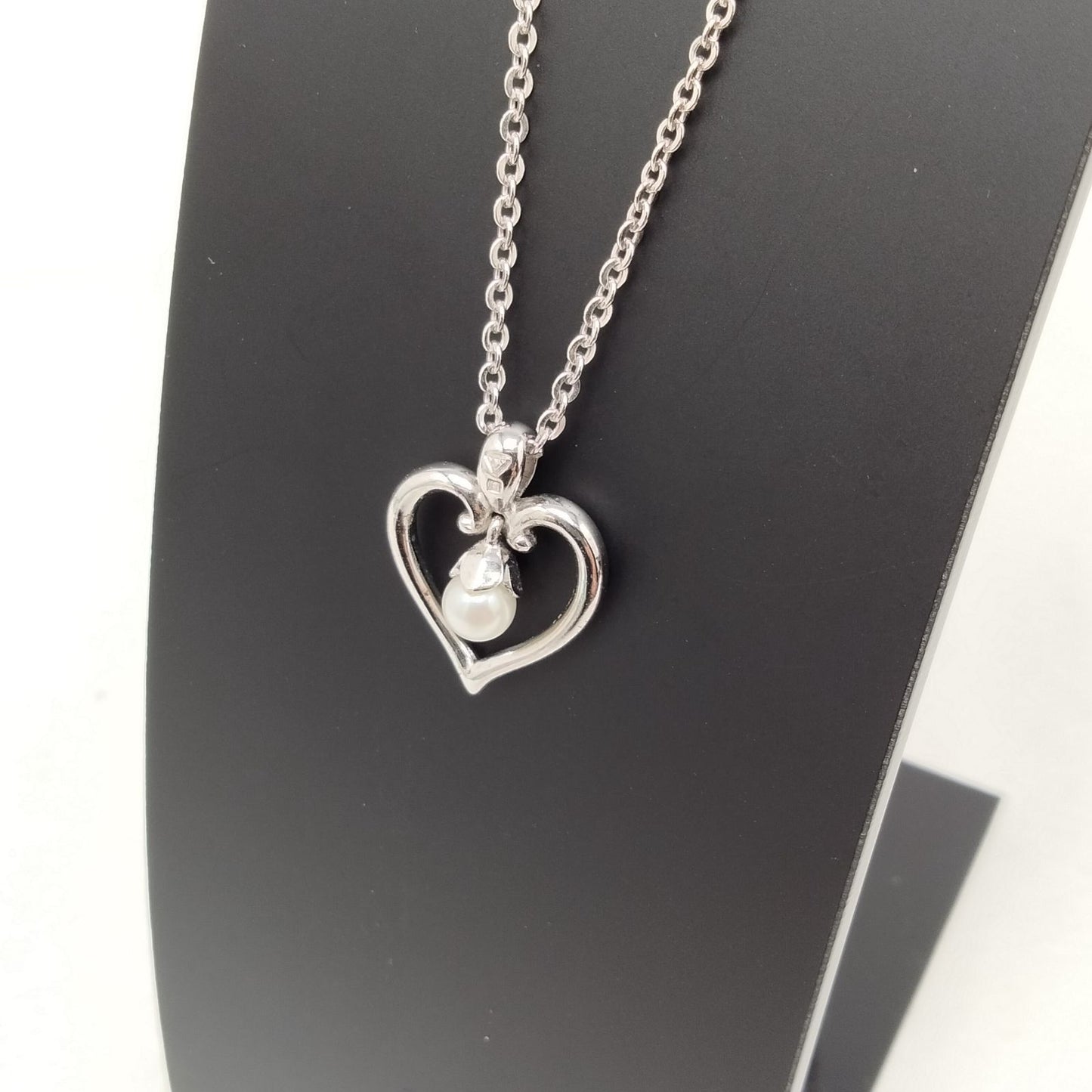 MIKIMOTO silver heart necklace with a 0.5cm pearl pendant and 19cm chain on white background