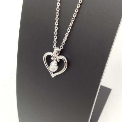 MIKIMOTO silver heart necklace with a 0.5cm pearl pendant and 19cm chain on white background